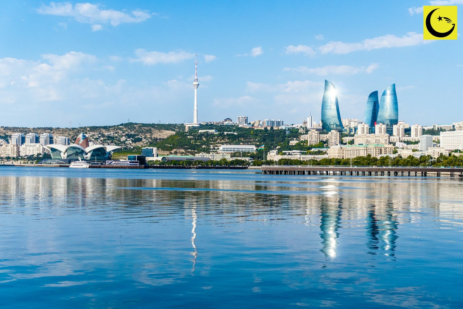Baku skyline with modern buildings reflected in calm blue water in Azerbaijan, file photo from the Pakistan U15 World Cup campaign in the city