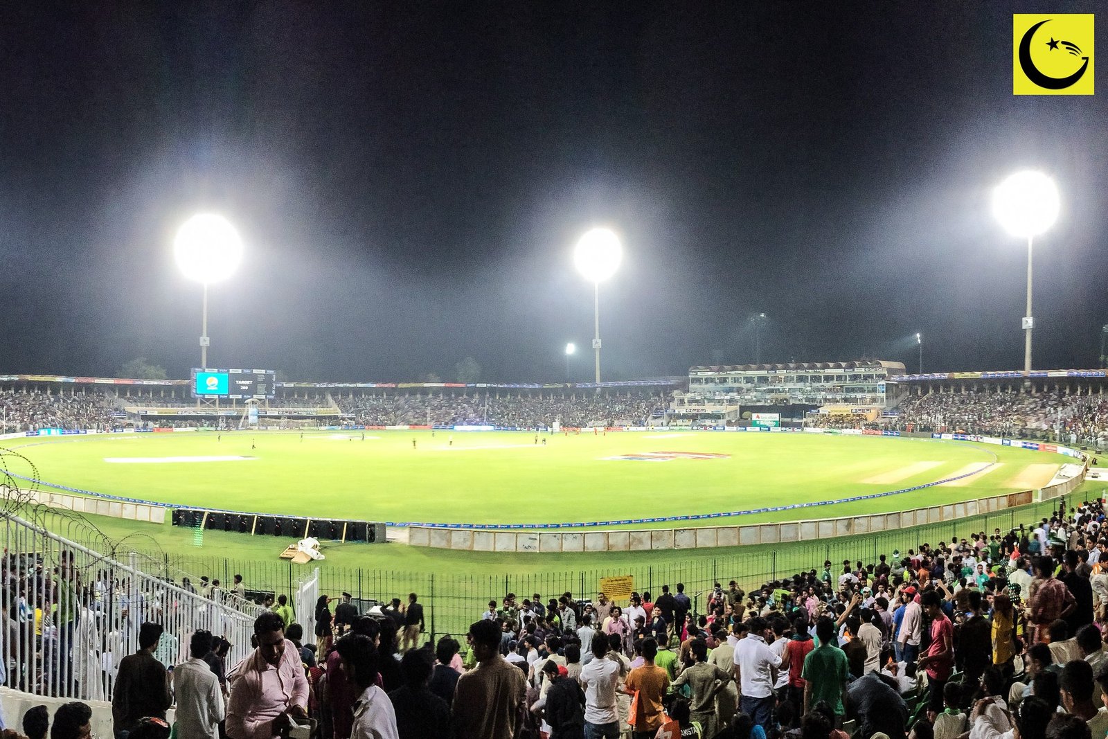 A cricket stadium under floodlights at night, as Pakistan prepare to defend their U19 Asia Cup 2026 title in Oman