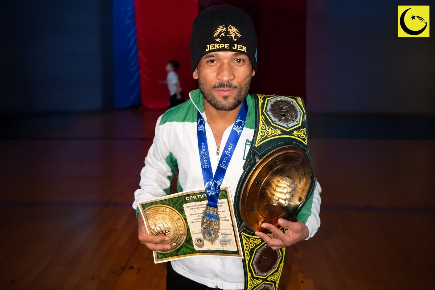 Sherbaz Marri gold medal winner holding the Nomad MMA championship belt and his winner's certificate in Kazakhstan